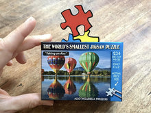 Picture of someone holding the Taking Airs puzzle box.