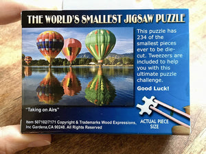 Back of puzzle box. This Puzzle has 234 of the smallest pieces ever to be die-cut/ Tweezer are included to help you with this ultimate puzzle challenge. Good Luck.